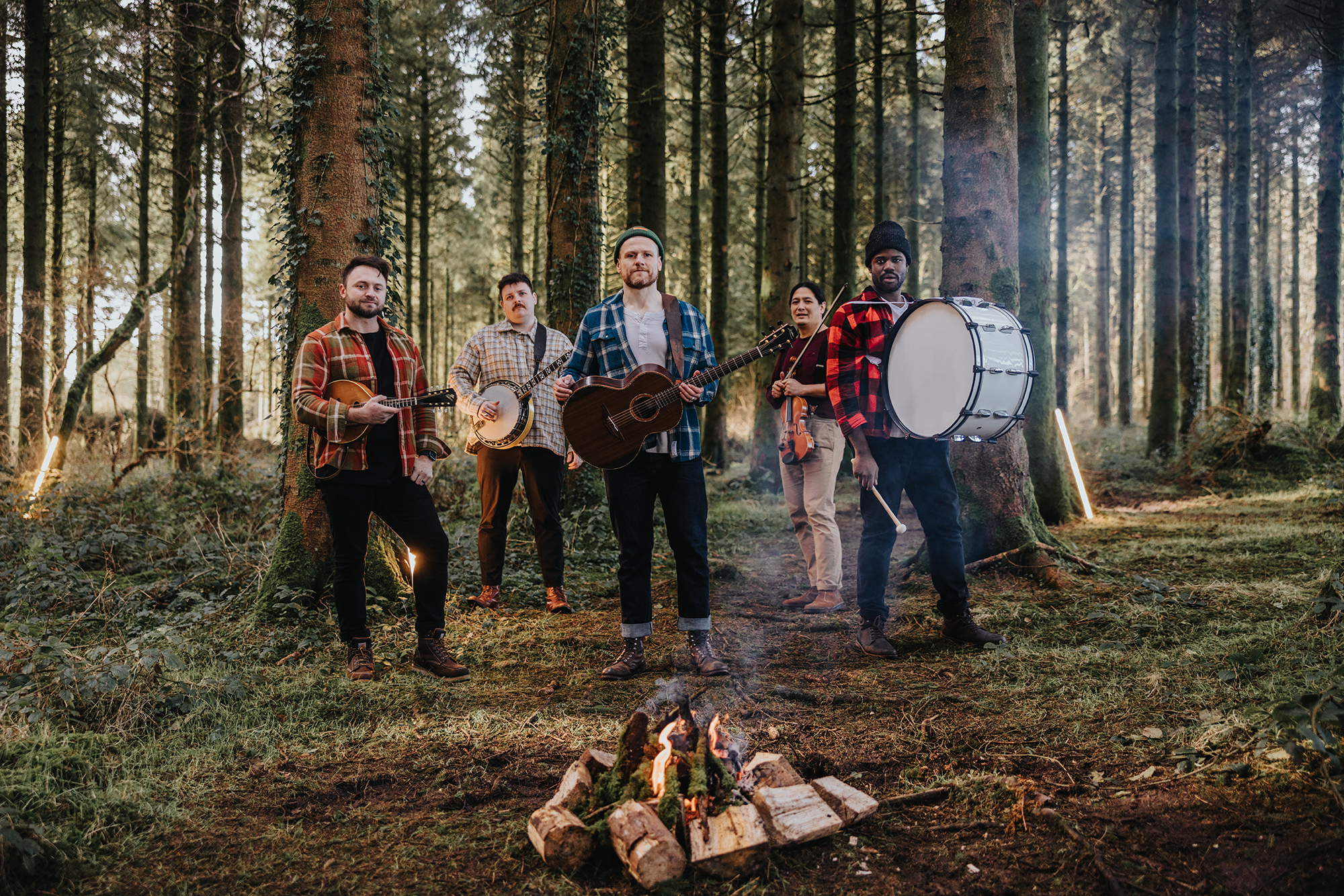 Rend Collective around a fire in the woods